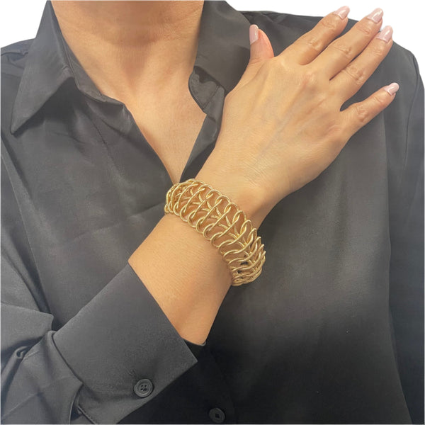 50-60's Italian 18k solid gold flexible woven link bracelet. Bracelet attaches with a push clasp.