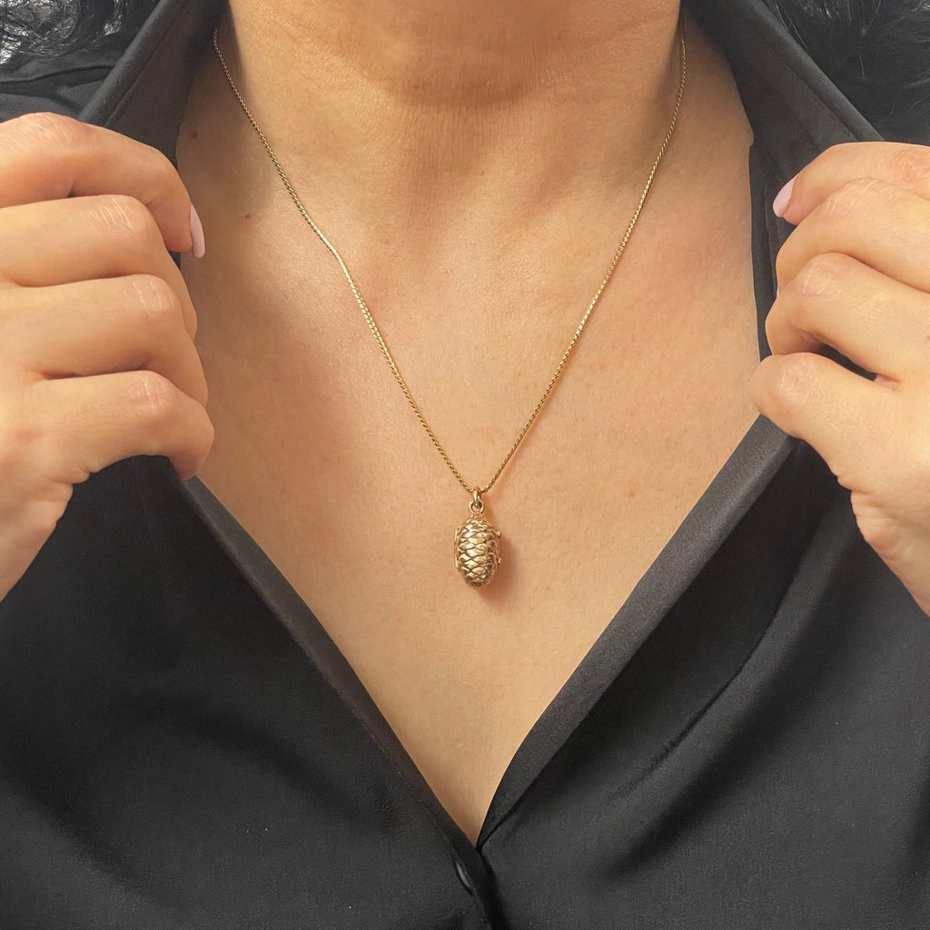 Vintage reliquary 14k yellow gold hollow pinecone locket pendant filled small mourning hair. Mourning jewelry (memento mori) where it was common to slip something personal into it.